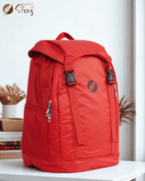 Bright red waterproof backpack with flap top buckle closure and side mesh pockets against a neutral background.